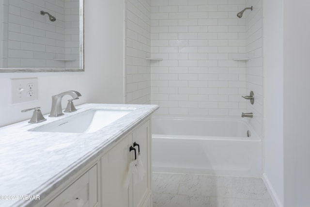 bathroom with vanity and tiled shower / bath