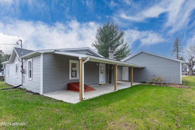 back of property featuring a yard and a patio