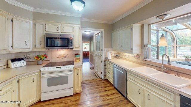 524 Pardee Rd, Millmont, PA 17845 - kitchen with appliances with stainless steel finishes, light wood-style floors, tasteful backsplash, and ornamental molding