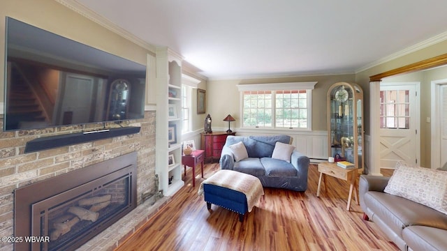 524 Pardee Rd, Millmont, PA 17845 - living room with wood finished floors, crown molding, a fireplace, wainscoting, and baseboard heating