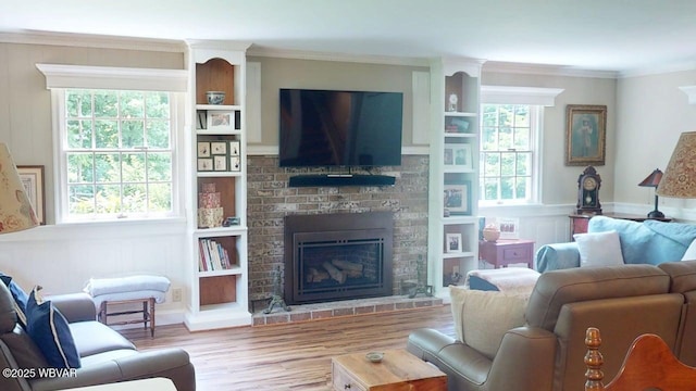 524 Pardee Rd, Millmont, PA 17845 - living room featuring wood finished floors, ornamental molding, plenty of natural light, a brick fireplace, and built in shelves