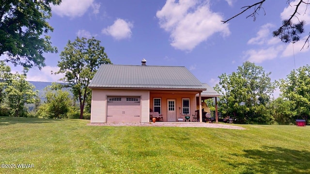 524 Pardee Rd, Millmont, PA 17845 - back of property with a garage, a yard, a porch, and a metal roof
