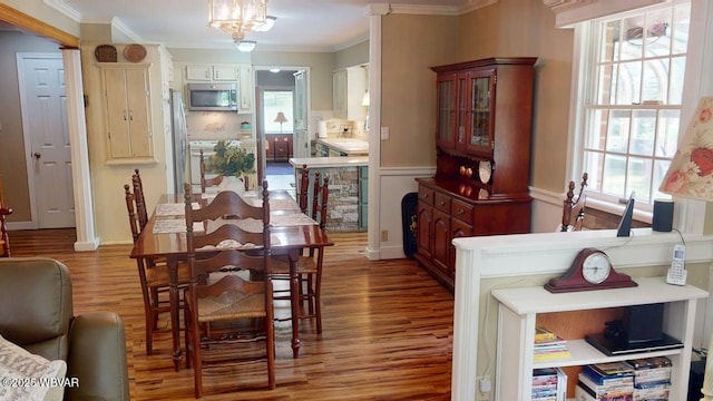 524 Pardee Rd, Millmont, PA 17845 - dining room with light wood-type flooring, ornamental molding, plenty of natural light, and wainscoting