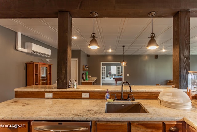 kitchen with sink, dishwasher, a wall mounted AC, light stone countertops, and decorative light fixtures