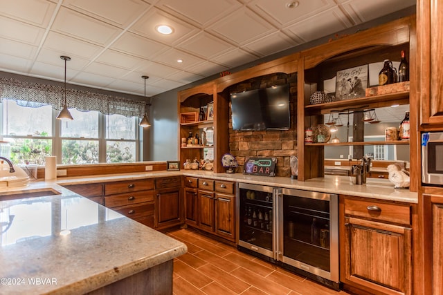 bar with pendant lighting, coffered ceiling, sink, and wine cooler