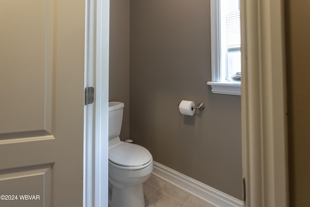 bathroom with toilet and tile patterned flooring