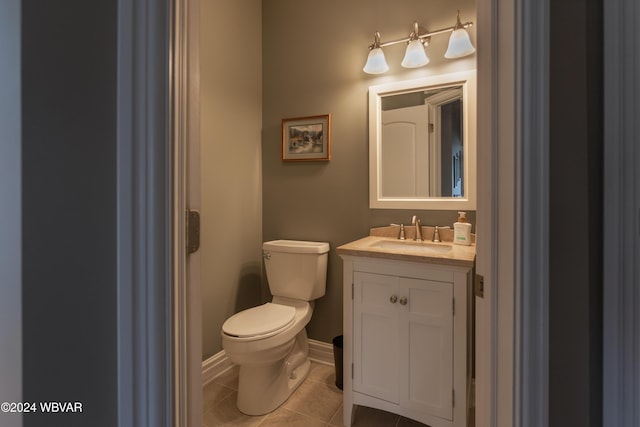 bathroom with vanity, toilet, and tile patterned flooring