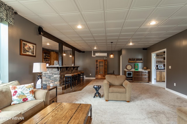 carpeted living room featuring bar area and a wall unit AC