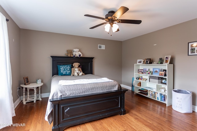 bedroom with wood-type flooring and ceiling fan