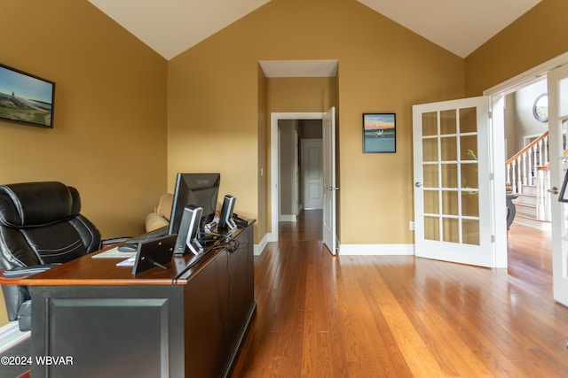 office space with french doors, light hardwood / wood-style floors, and vaulted ceiling