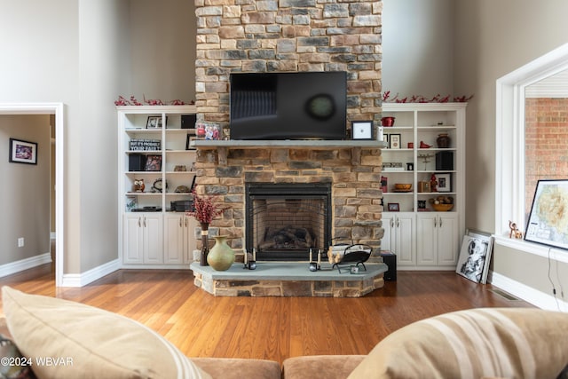 living room with wood-type flooring and a fireplace