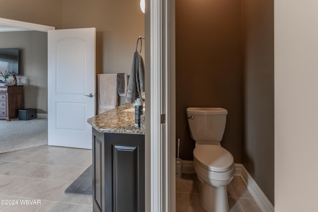 bathroom featuring tile patterned flooring, vanity, and toilet