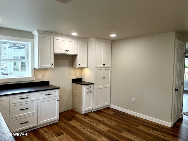 218 High St, Lock Haven, PA 17745 - kitchen with dark countertops, dark wood-style floors, white cabinets, and recessed lighting