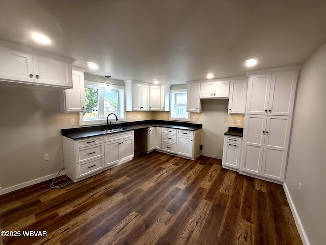 218 High St, Lock Haven, PA 17745 - kitchen with dark wood-type flooring, dark countertops, white cabinets, and recessed lighting