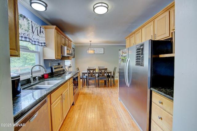260 Selkirk Rd, Williamsport, PA 17701 - kitchen with stainless steel appliances, a sink, crown molding, dark stone counters, and light wood-style flooring