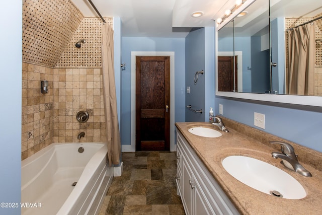 full bath featuring stone finish flooring, a sink, shower / bathtub combination with curtain, and double vanity