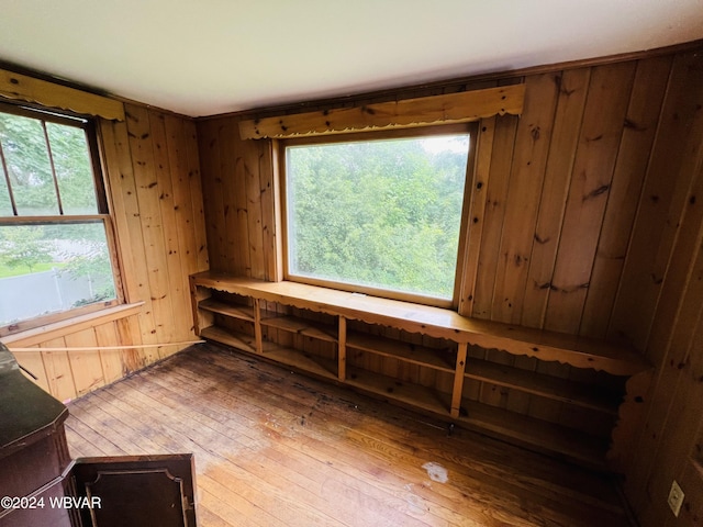 miscellaneous room featuring wooden walls and hardwood / wood-style floors