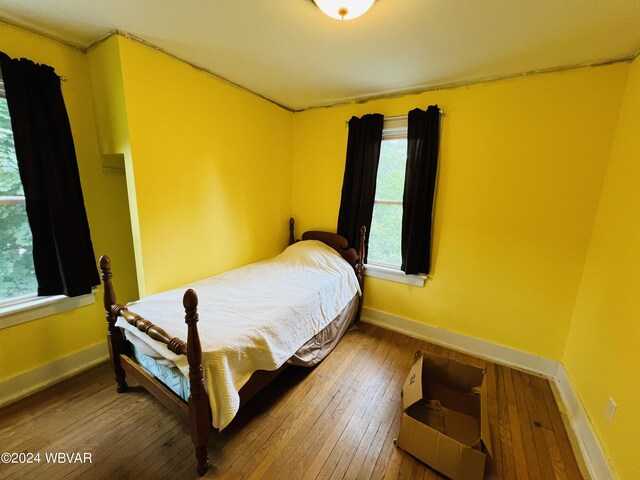 bedroom with hardwood / wood-style floors