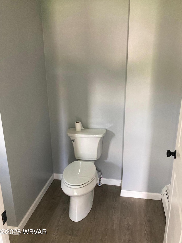 215 E 8th St, Watsontown, PA 17777 - bathroom featuring baseboards, toilet, a baseboard radiator, and wood finished floors
