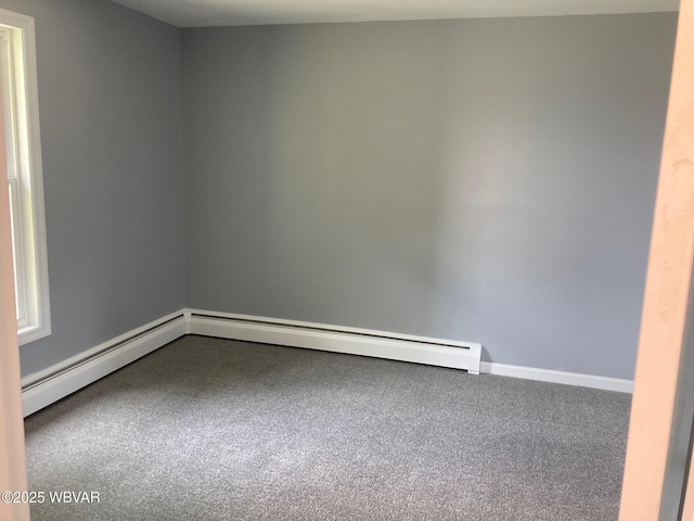215 E 8th St, Watsontown, PA 17777 - carpeted empty room featuring baseboards and a baseboard heating unit