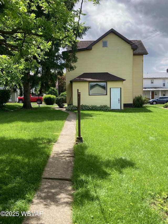 215 E 8th St, Watsontown, PA 17777 - view of property exterior featuring a yard