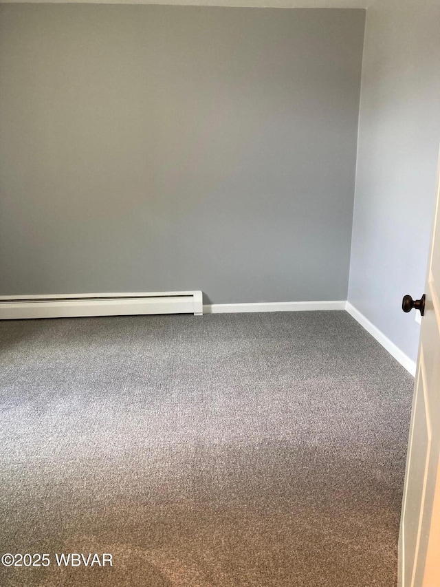 215 E 8th St, Watsontown, PA 17777 - unfurnished room featuring baseboards, carpet, and a baseboard heating unit