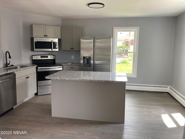 215 E 8th St, Watsontown, PA 17777 - kitchen featuring stainless steel appliances, a sink, a kitchen island, and light stone counters