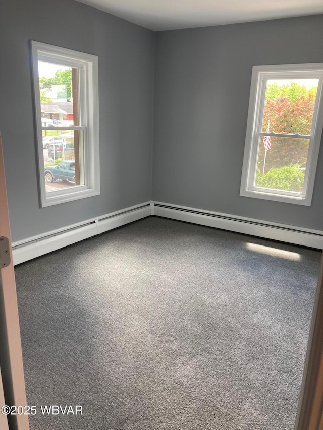 215 E 8th St, Watsontown, PA 17777 - spare room featuring plenty of natural light, carpet flooring, and a baseboard heating unit