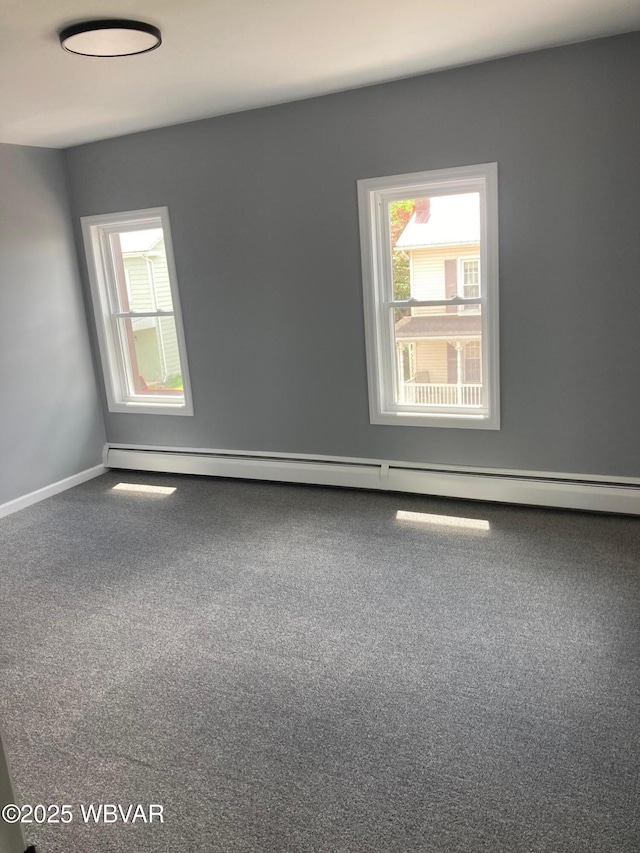 215 E 8th St, Watsontown, PA 17777 - empty room with baseboard heating, carpet floors, and baseboards