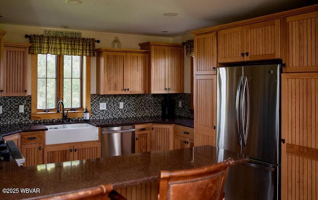 796 Ellis Artley Rd, Muncy, PA 17756 - kitchen featuring appliances with stainless steel finishes, a sink, decorative backsplash, dark stone counters, and a peninsula