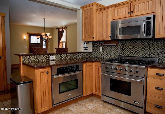 796 Ellis Artley Rd, Muncy, PA 17756 - kitchen featuring appliances with stainless steel finishes, a chandelier, tasteful backsplash, a peninsula, and light tile patterned flooring
