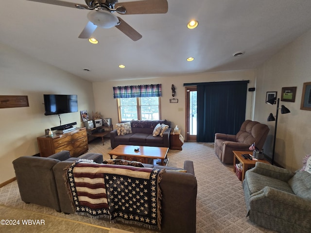 living room featuring ceiling fan, light carpet, and vaulted ceiling