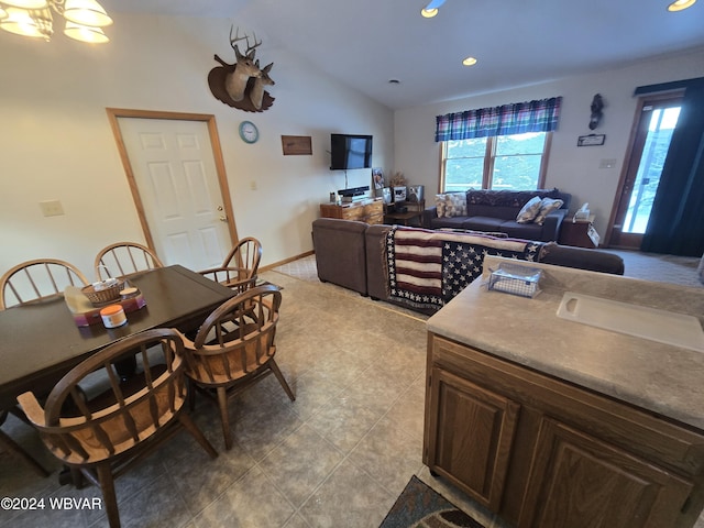 kitchen featuring dark brown cabinetry and vaulted ceiling