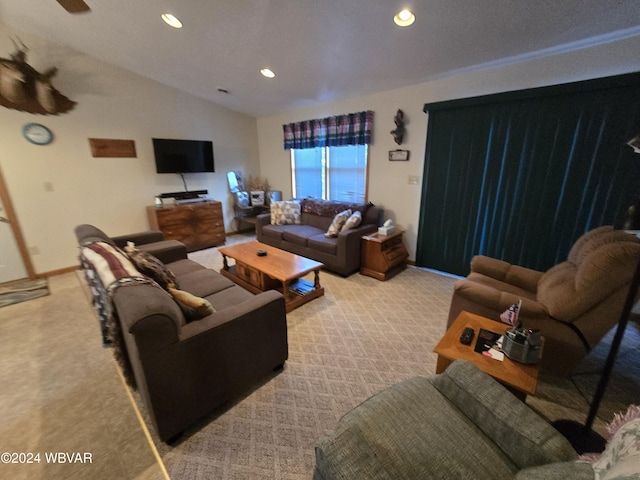 carpeted living room featuring ceiling fan and lofted ceiling