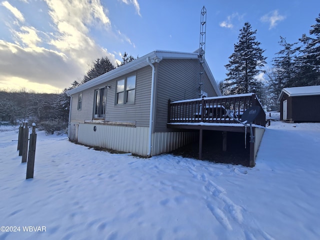 view of snowy exterior with an outbuilding