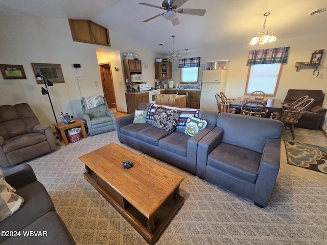 living room with ceiling fan with notable chandelier, lofted ceiling, and sink