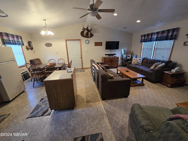 living room featuring ceiling fan with notable chandelier and lofted ceiling