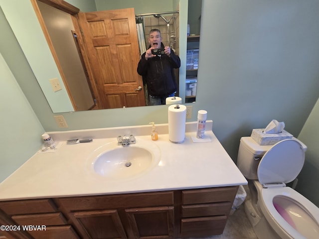 bathroom featuring vanity and toilet