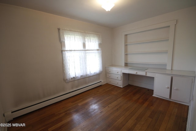 unfurnished office featuring baseboard heating, built in desk, dark wood finished floors, and built in shelves