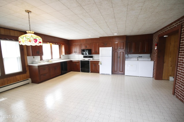 kitchen featuring black appliances, separate washer and dryer, light floors, light countertops, and brick wall
