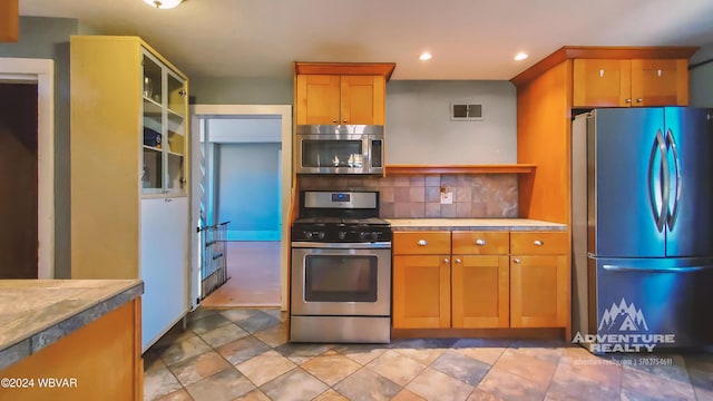 kitchen featuring decorative backsplash and stainless steel appliances