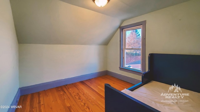 bonus room with light wood-type flooring and lofted ceiling