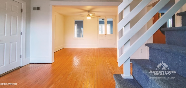 entryway with wood-type flooring and ceiling fan