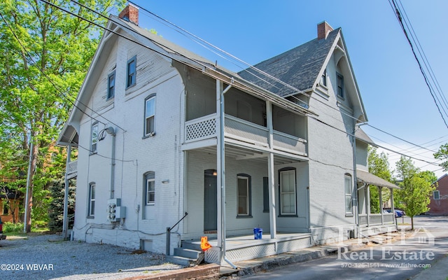 view of front of house with a porch and a balcony