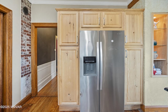 kitchen with stainless steel refrigerator with ice dispenser, light brown cabinets, crown molding, and wood finished floors