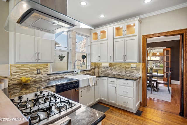kitchen featuring light wood-type flooring, crown molding, gas cooktop, stainless steel dishwasher, and a sink