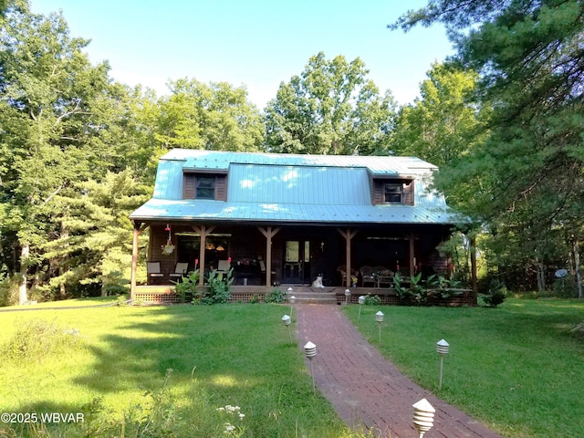 view of front of house with a porch, a front lawn, and metal roof