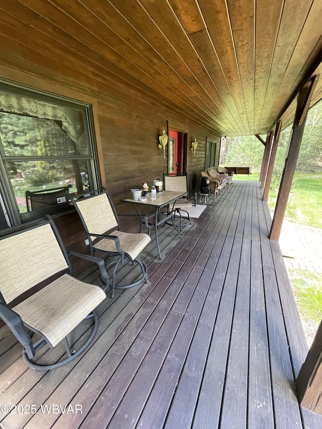 wooden deck featuring outdoor dining space
