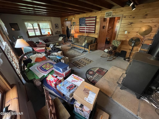 miscellaneous room with wooden walls and beam ceiling