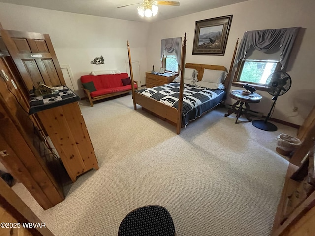 bedroom featuring light colored carpet, ceiling fan, and baseboards